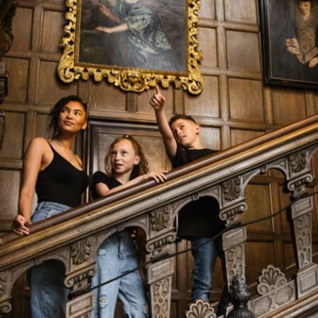 Family on the oak stairs at Temple Newsam
