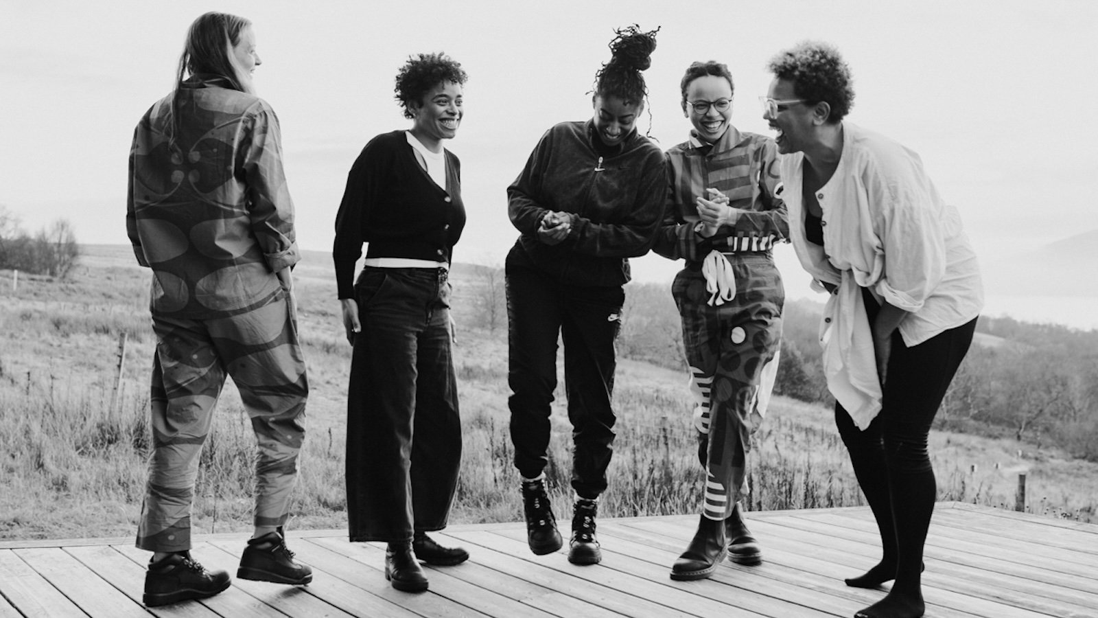 Black and white image of four women on a boardwalk