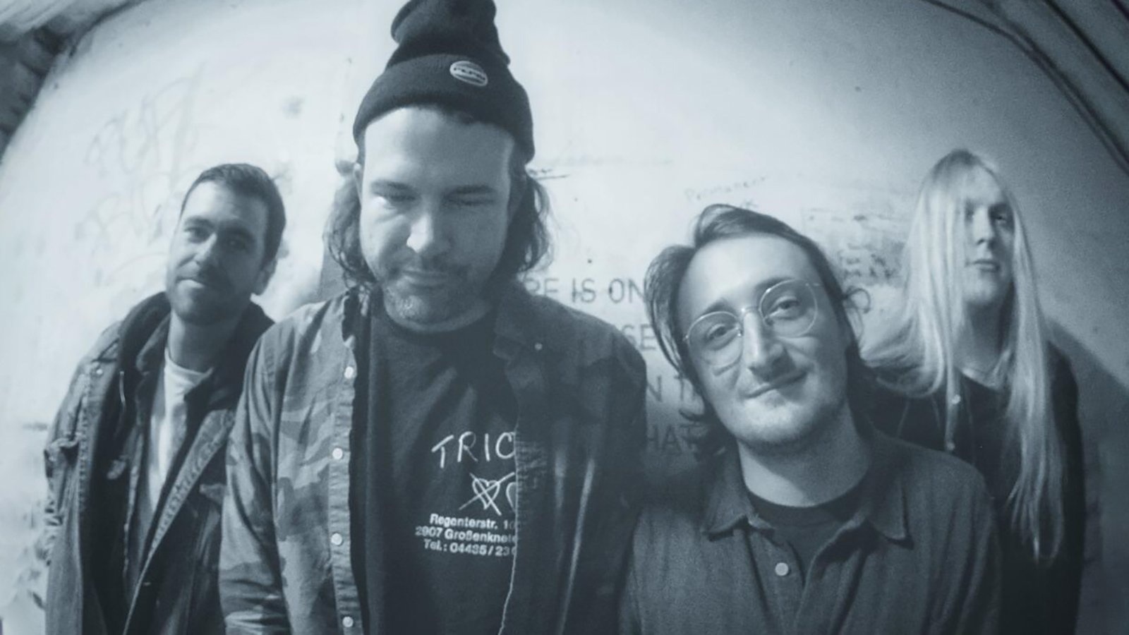 A black and white photo of Wild Pink posing