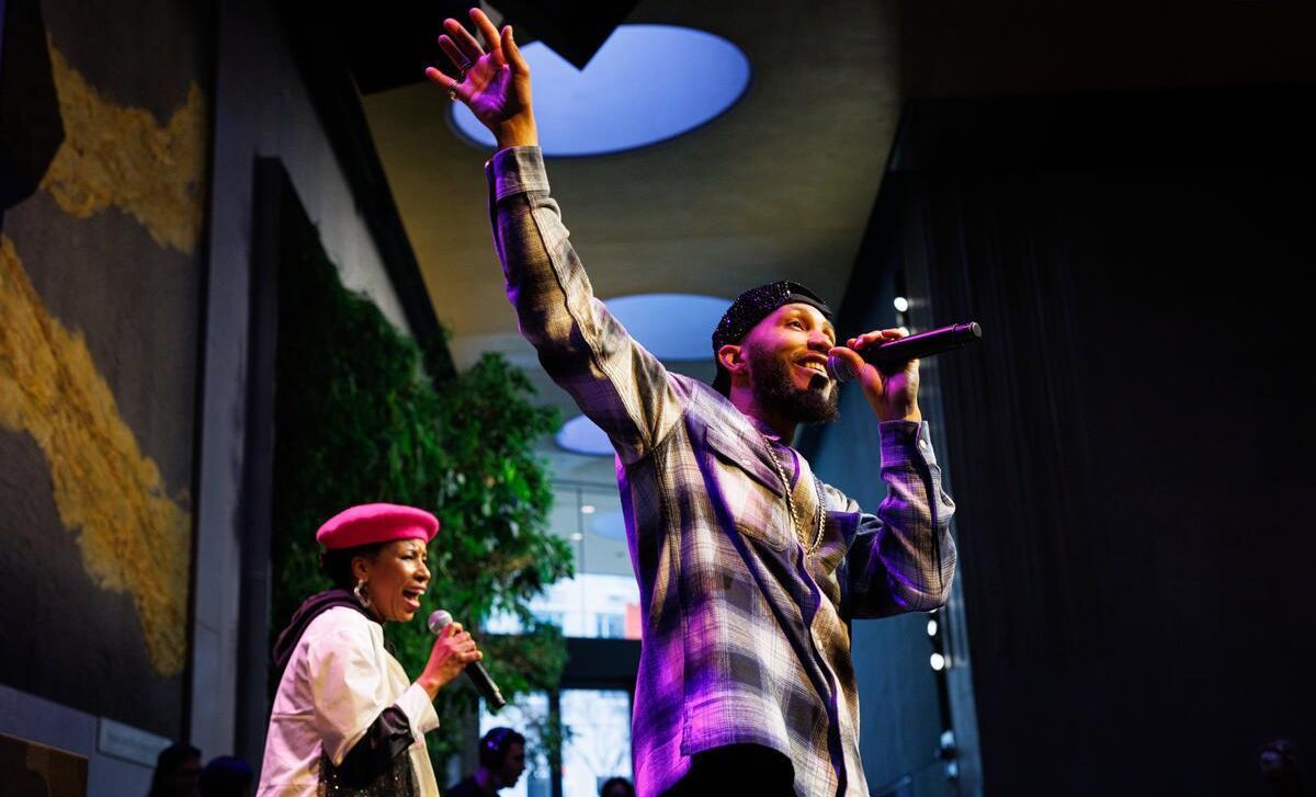 A black man and woman performing on stage at the Atrium