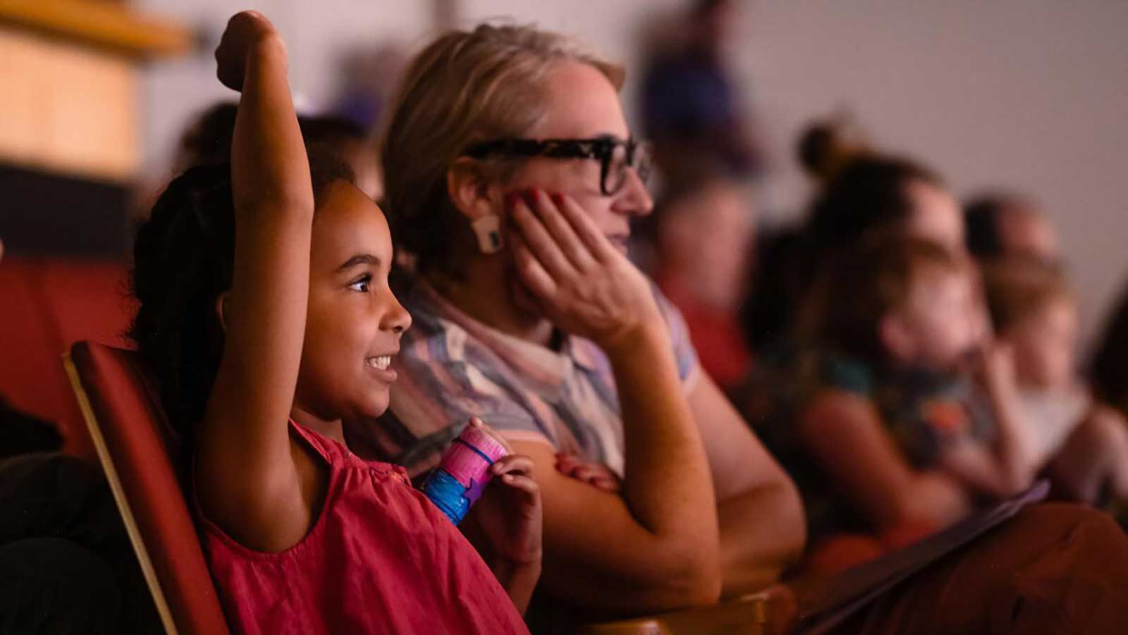 a young girl and woman in an audience