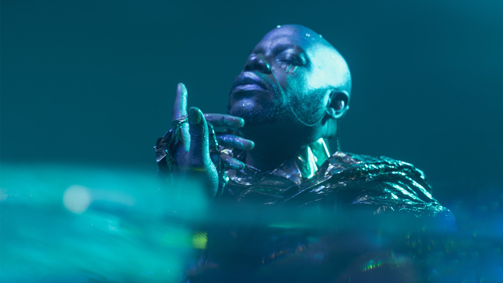 an artist with his eyes closed and his head tilted up