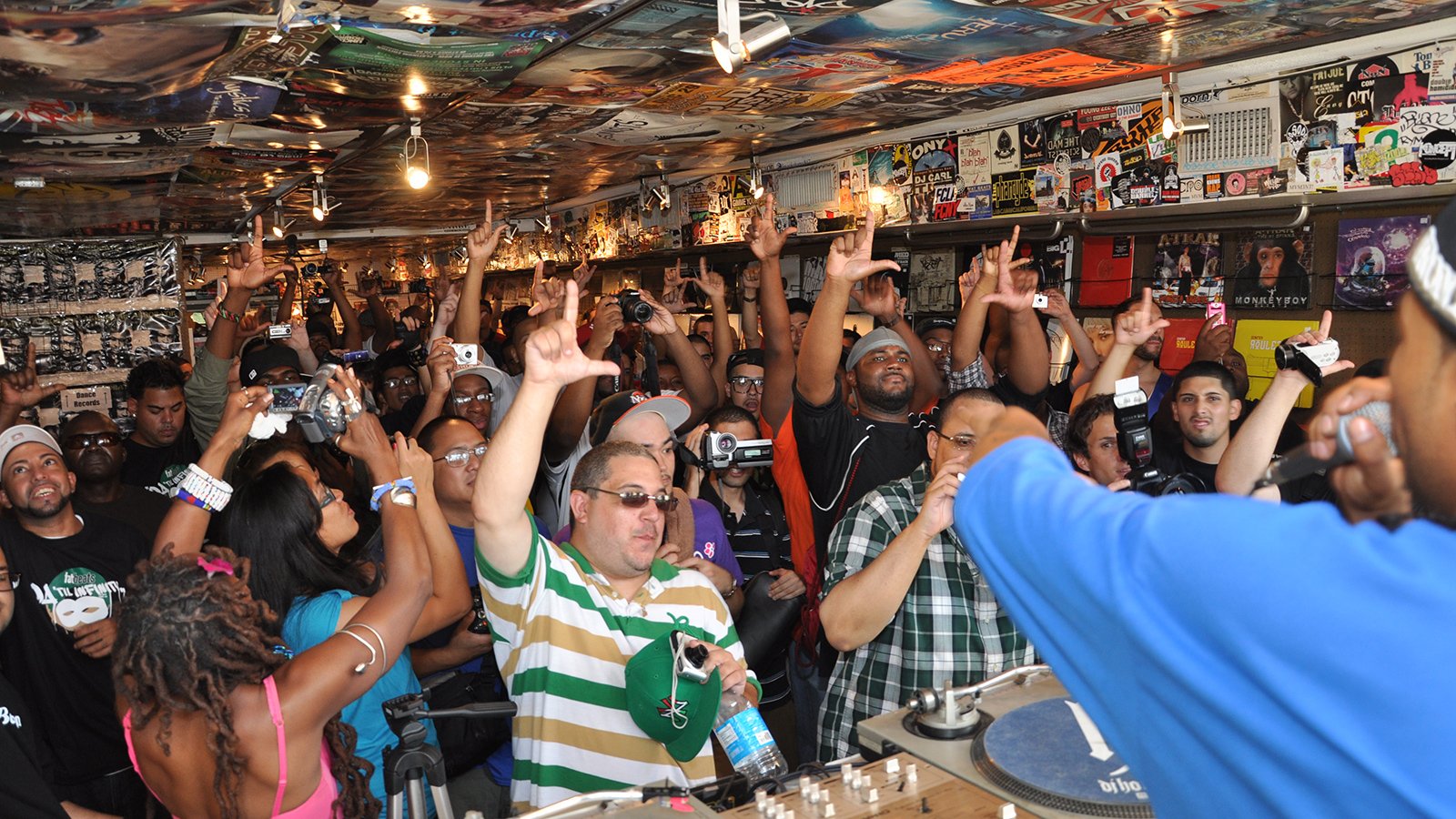 An audience dances in front of a DJ
