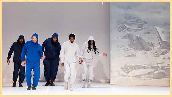 Five dancers in track suits dance on a white background.