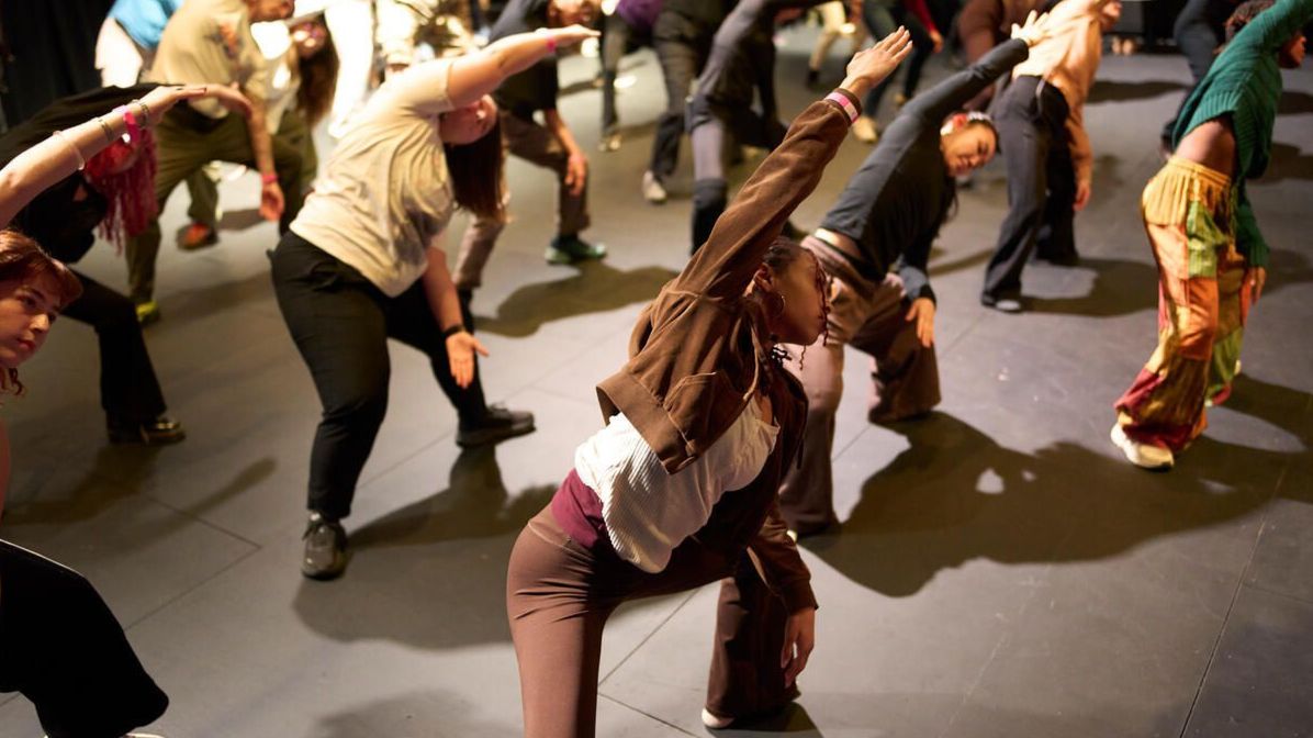 People lean into a side lunge during a movement session