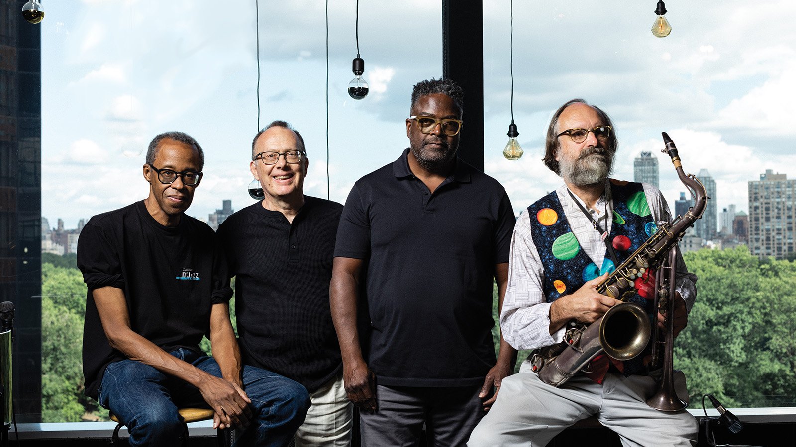 The four members of East Axis pose by a window overlooking Central Park