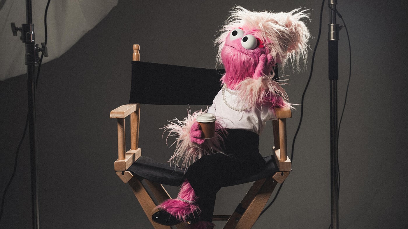 A puppet sits on a chair
