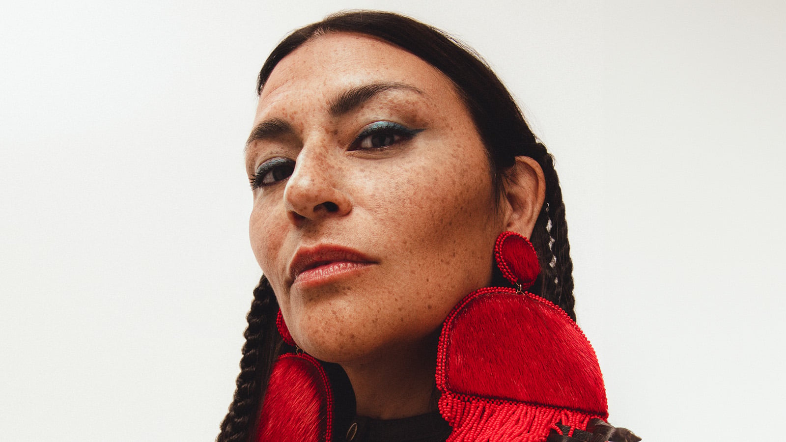A woman wears red earrings
