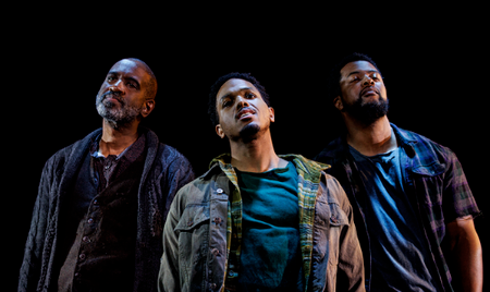 Three men look out into the audience