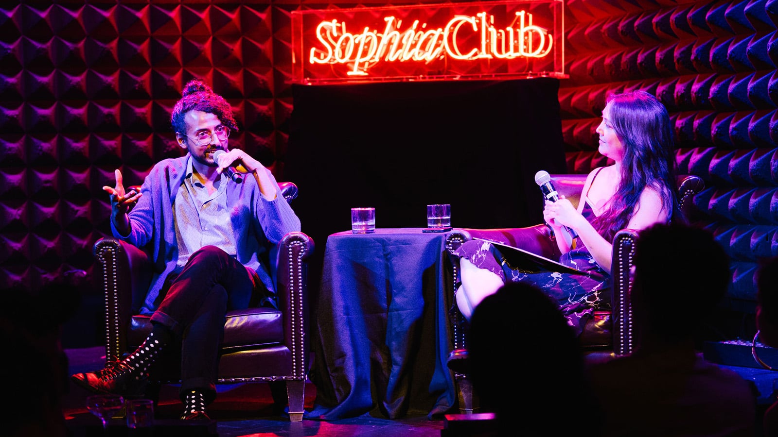People have a conversation at a club