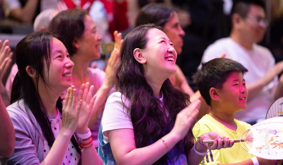 Three men look out into the audience