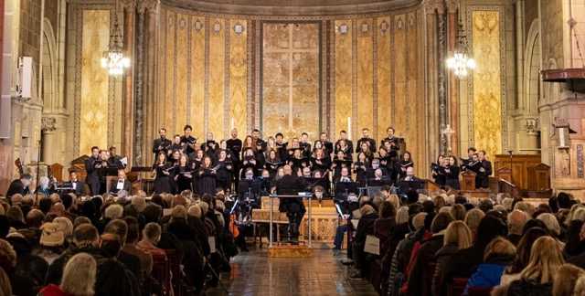Three men look out into the audience