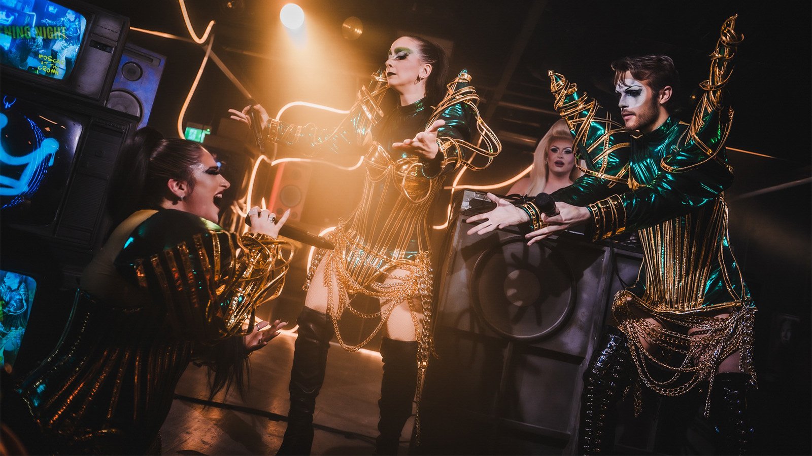 An image of Fusilier in a leather vest and a polo standing against a blue wall