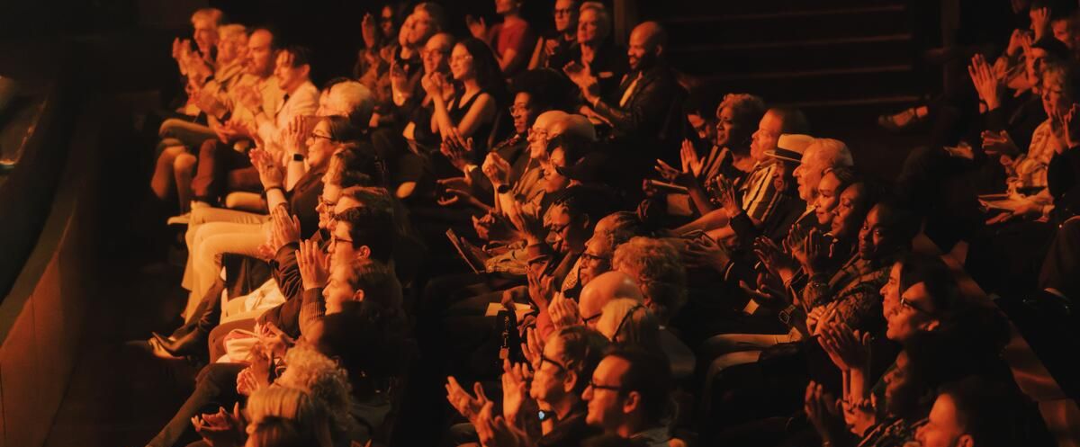 An audience applauds