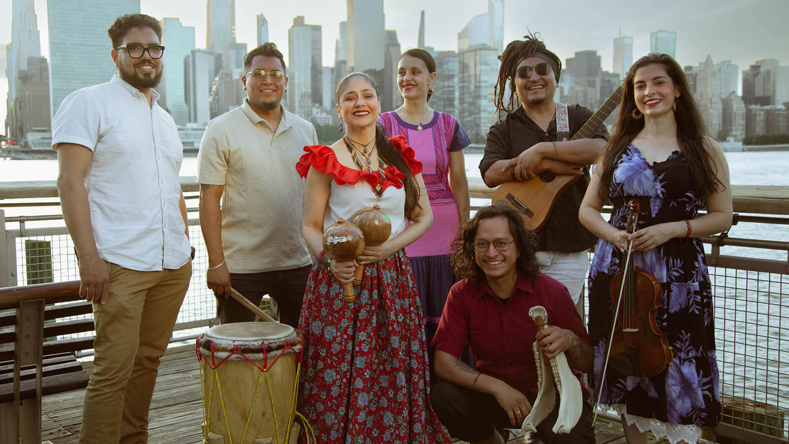 People pose in front of the skyline