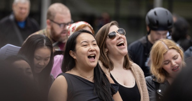 Three men look out into the audience