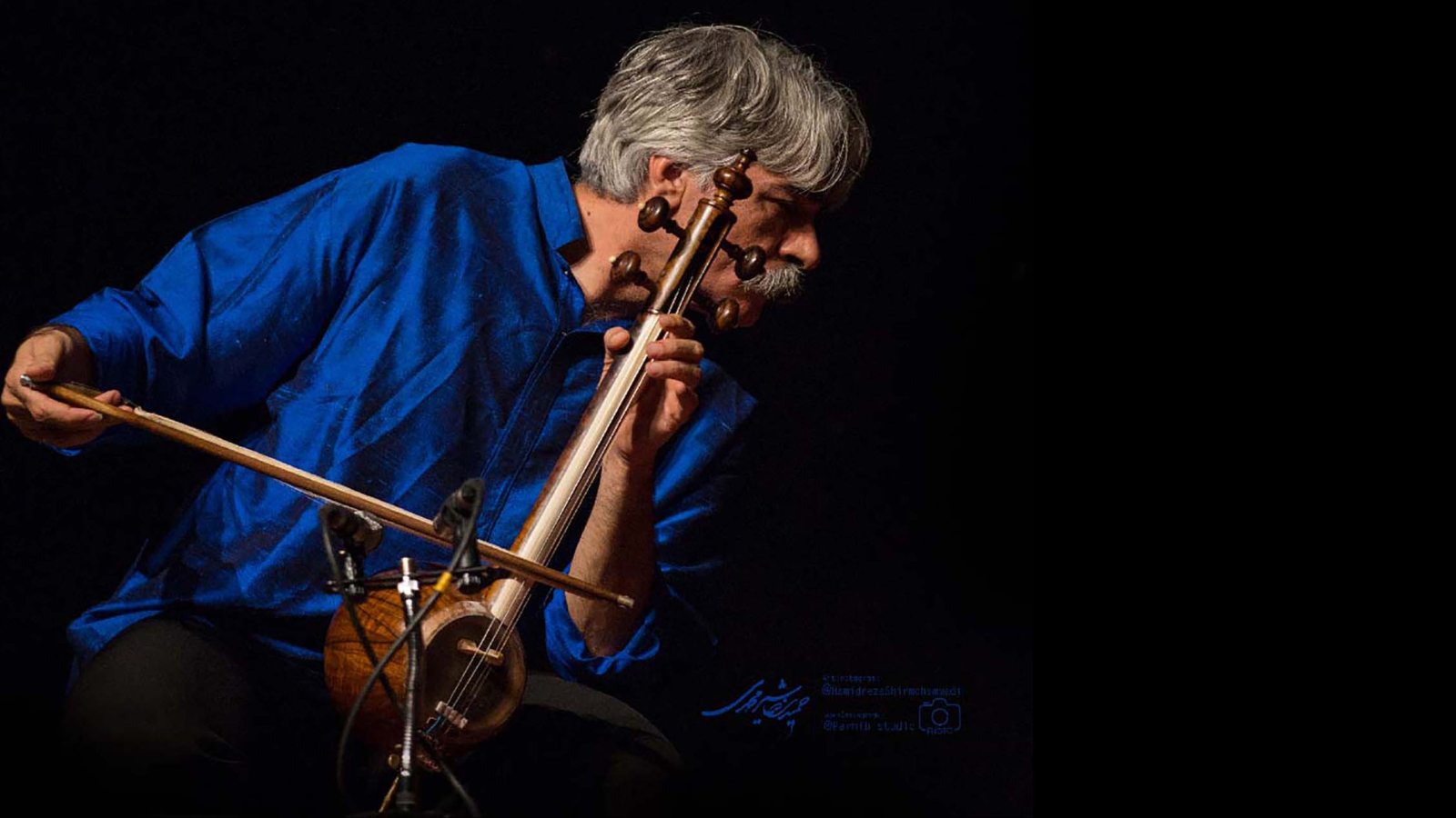 Three men look out into the audience