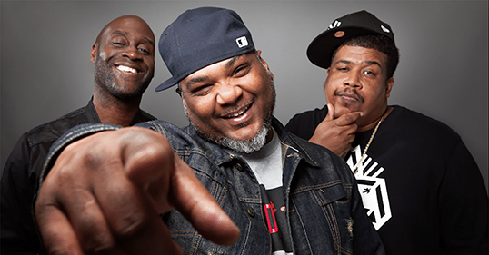 The members of De La Soul smile at the camera