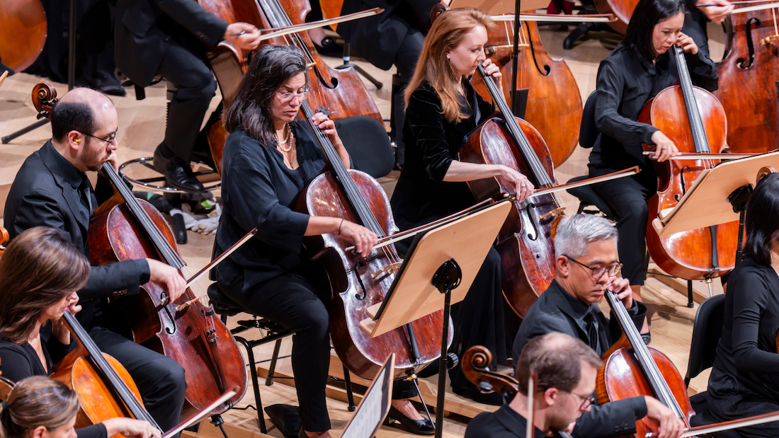 An image of the NY Phil's cello section playing in a concert