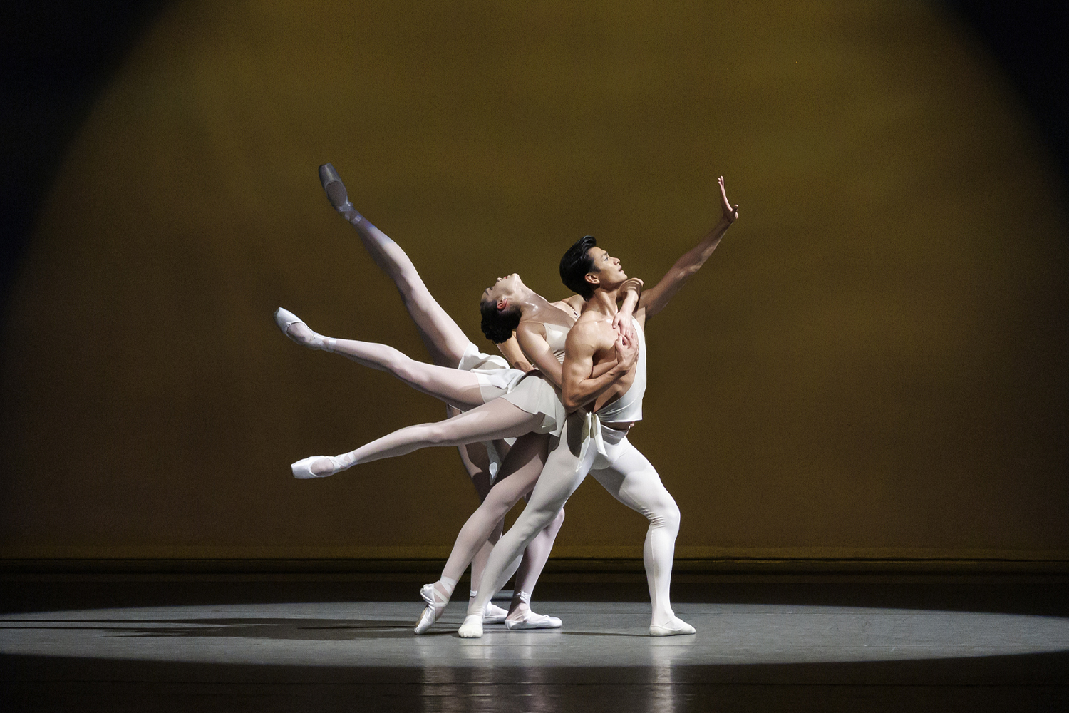 Ballet dancers in white outfits on stage