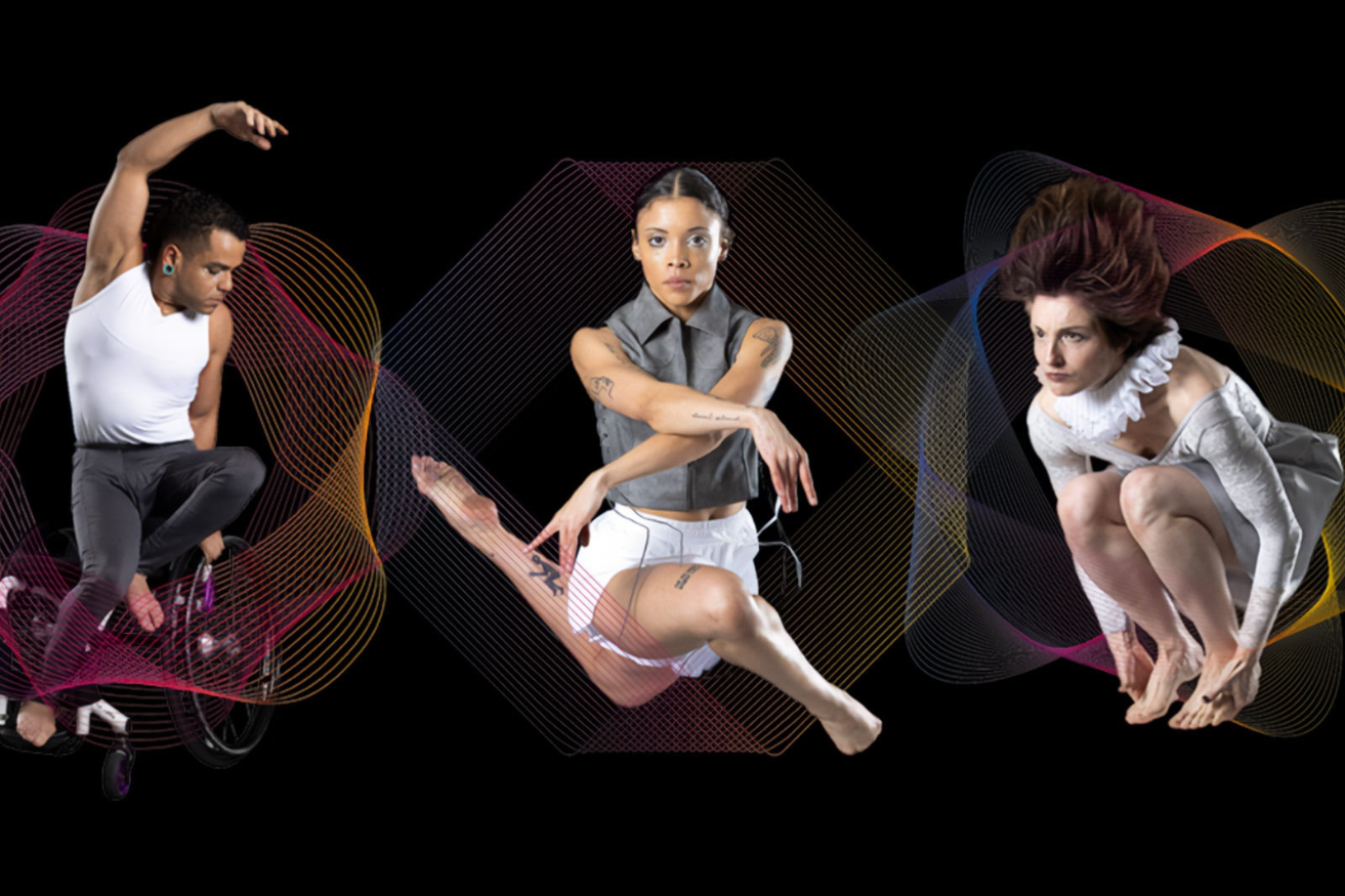 A man in a yellow t-shirt laying on his side in front of a projected version of Hamlet