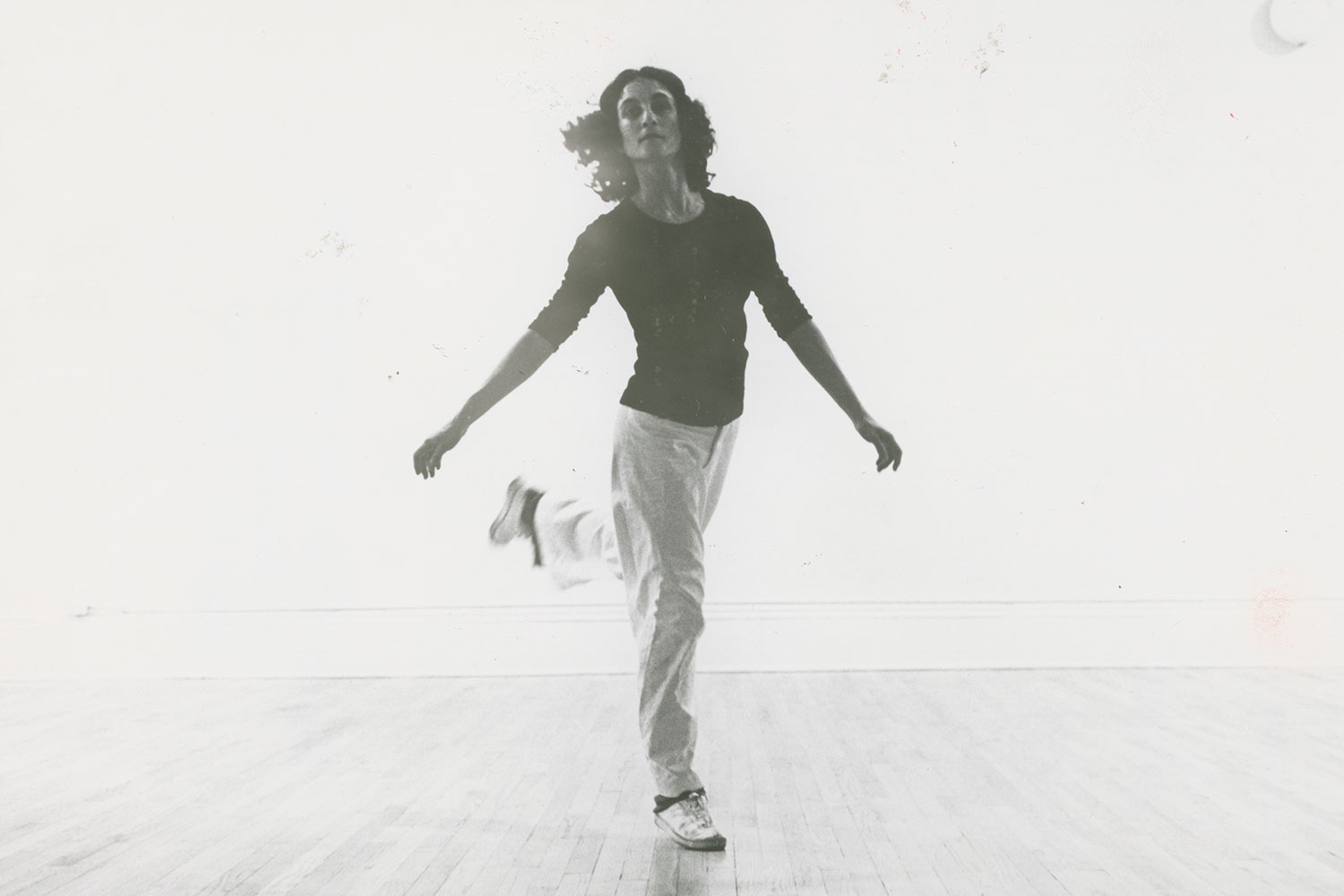 A woman sitting on a plush bench holding a cello