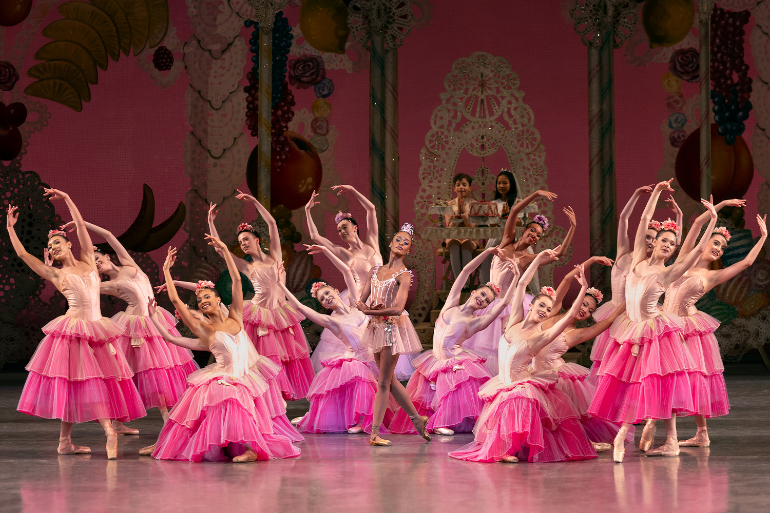 Ballerinas posing on stage in pink dresses