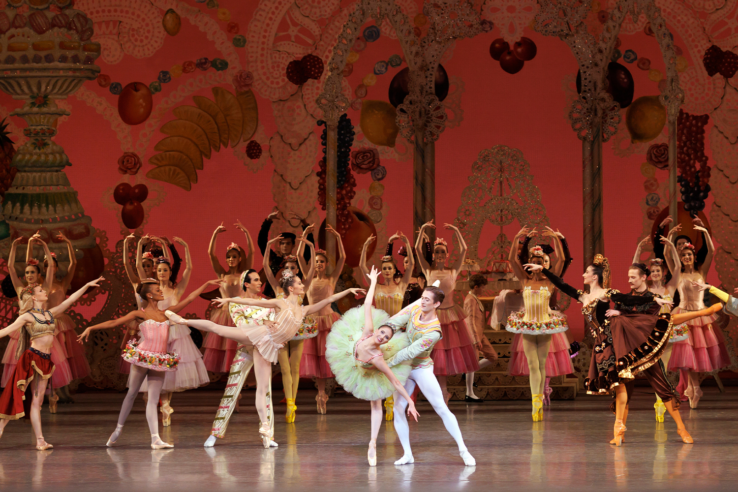 Ballet dancers in white outfits on stage