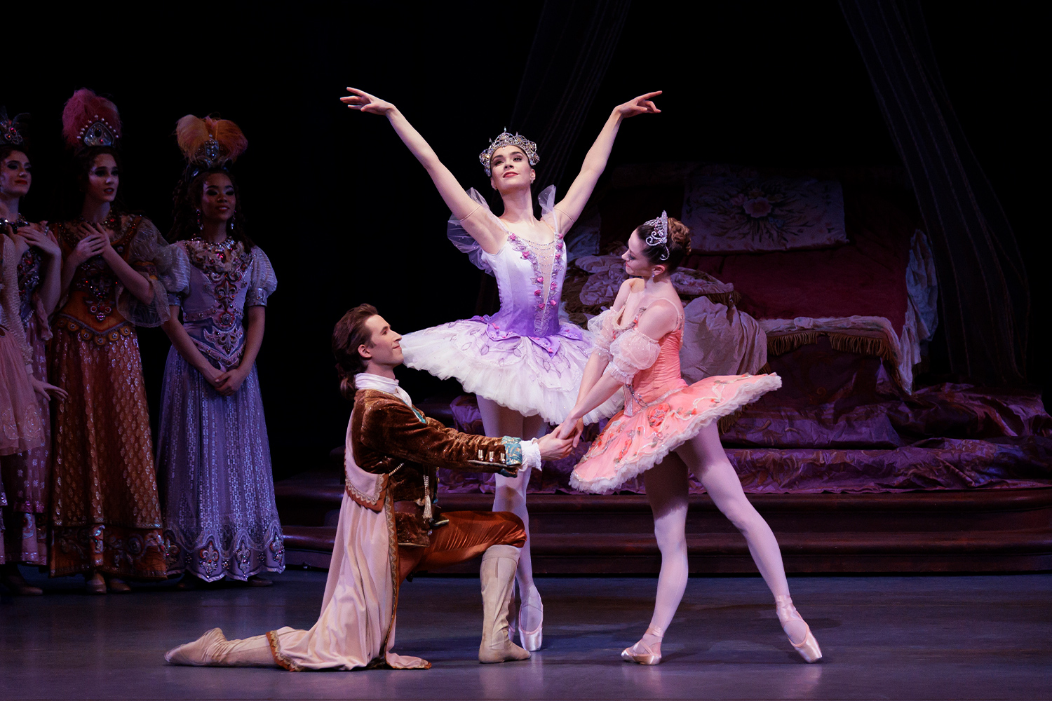 Ballet dancers in white outfits on stage