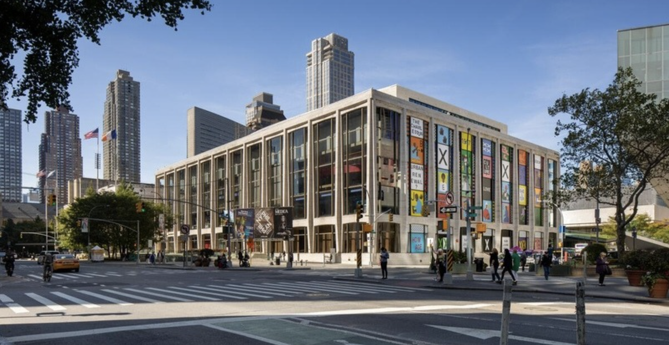 People walking through the Lincoln Center plaza at night