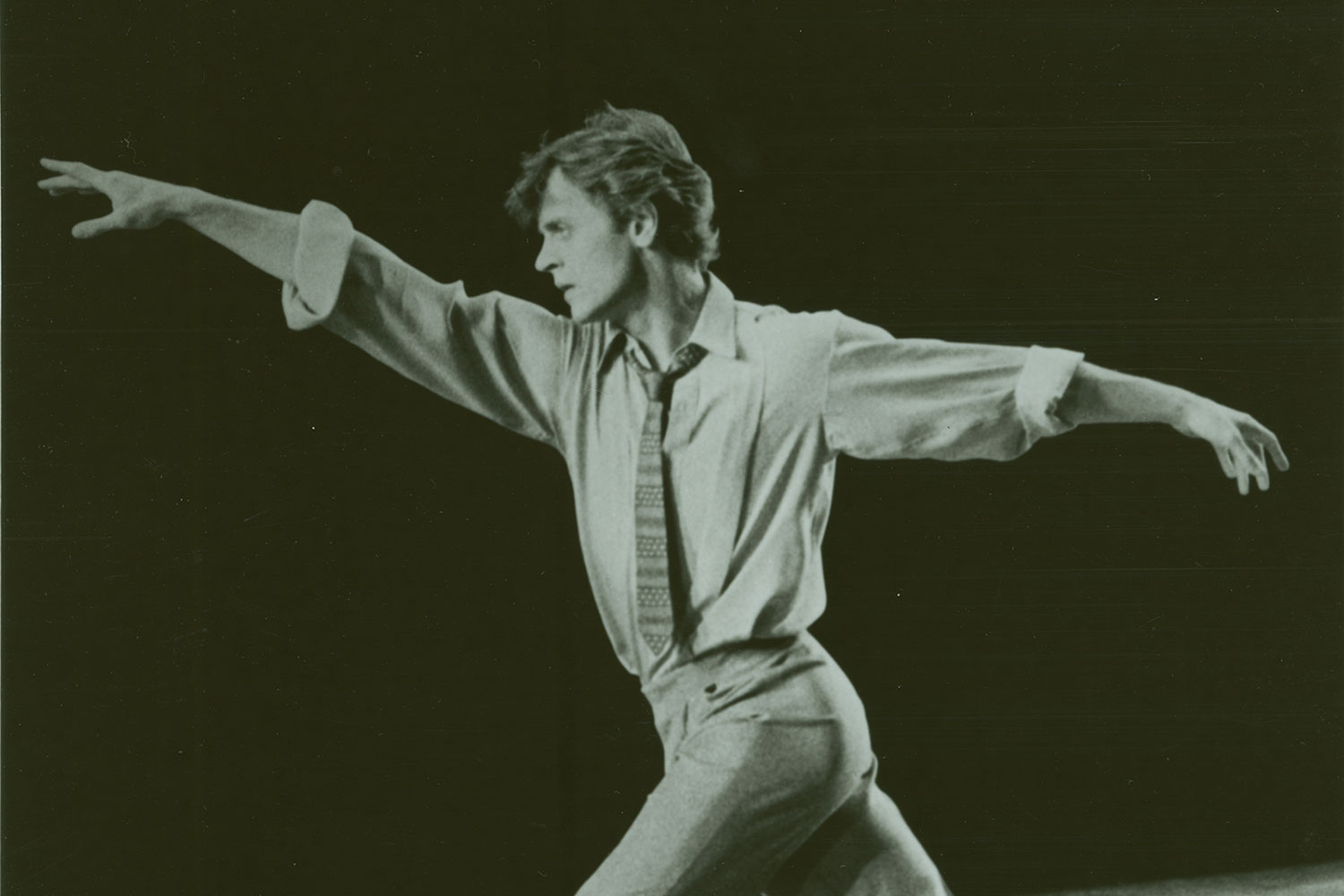 A black and white photo of a man dancing