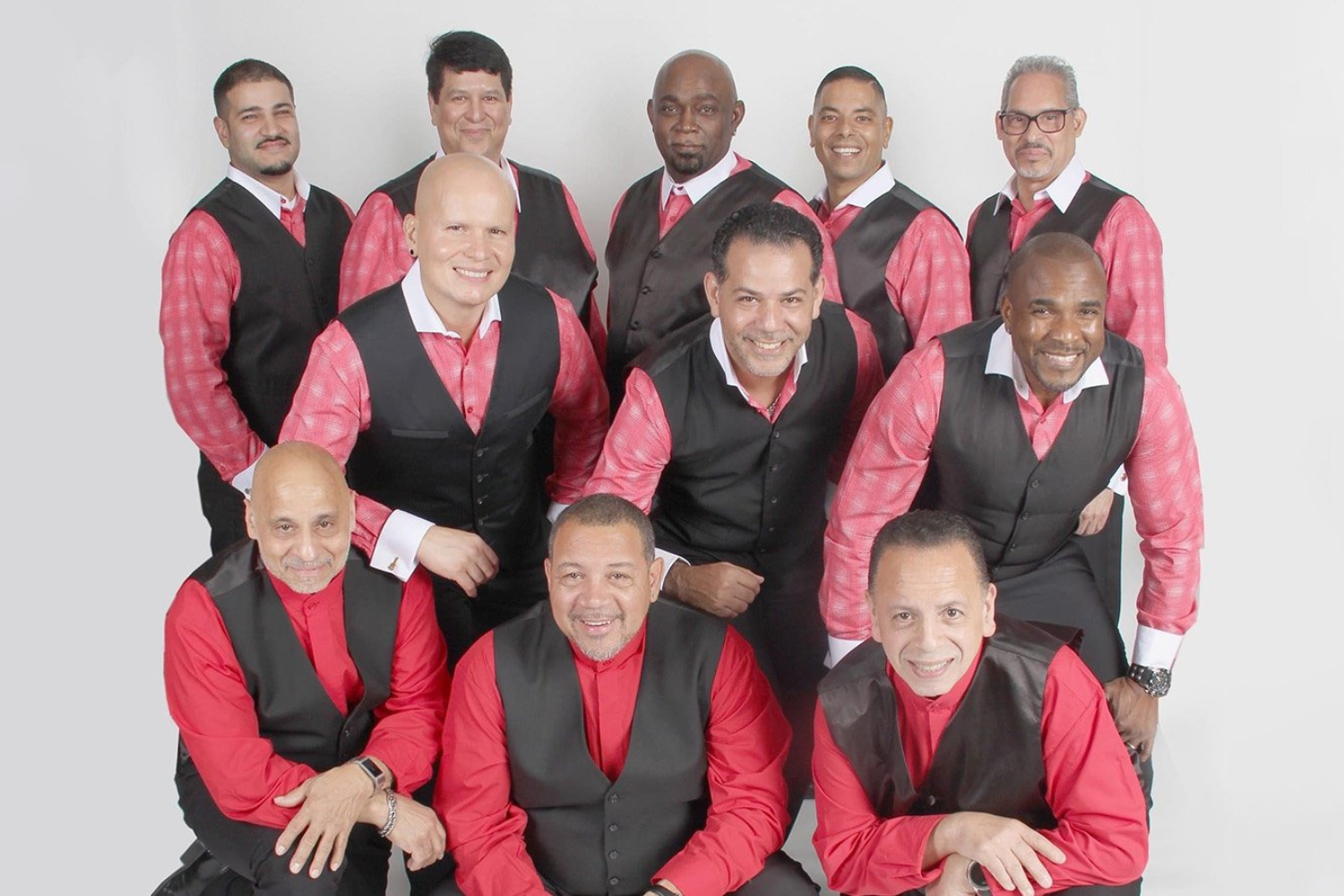 A man in a yellow t-shirt laying on his side in front of a projected version of Hamlet