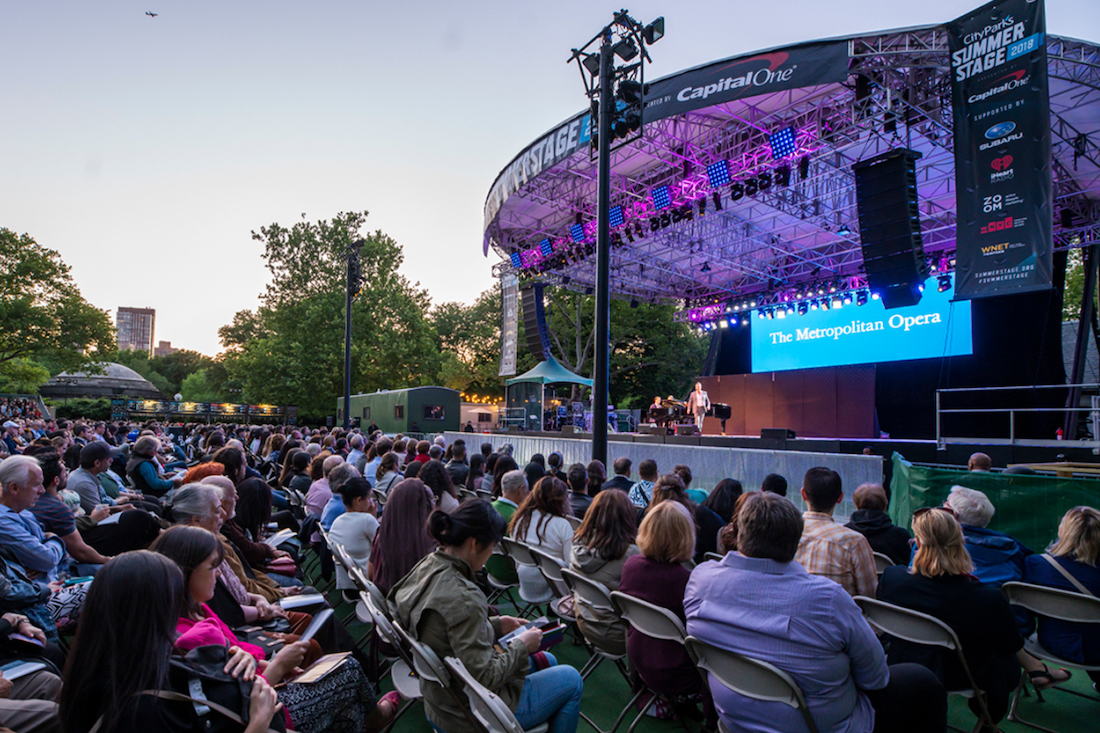 Audience watching a performance at an outdoor stage