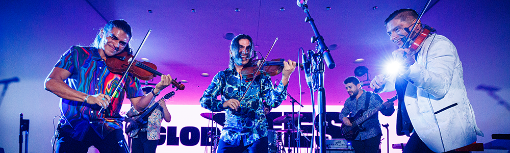 Musicians play stringed instruments on stage