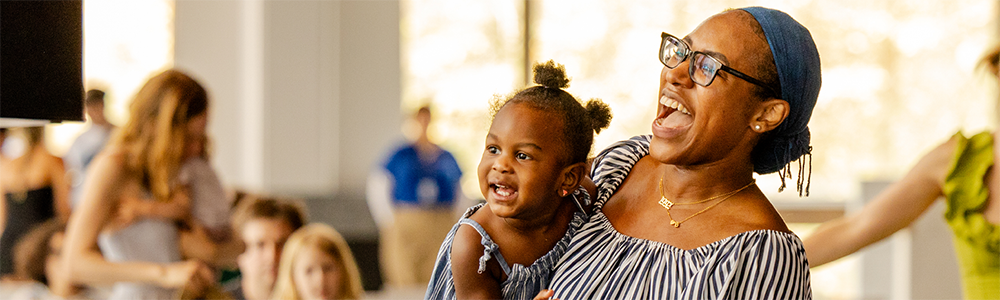 A woman and a small child laugh