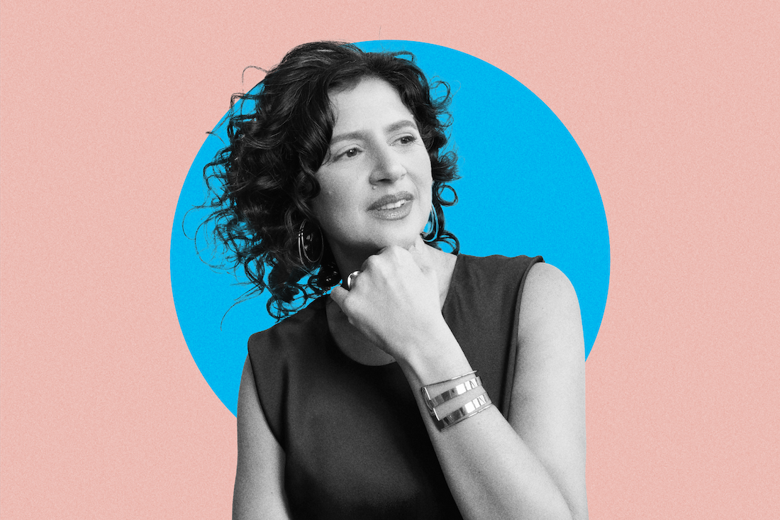 A black and white photo of a woman with dark curly hair in front of a pink and blue graphic