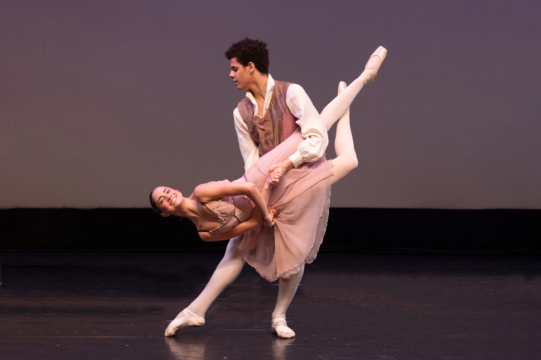 A male ballet dancer lifting a ballerina 