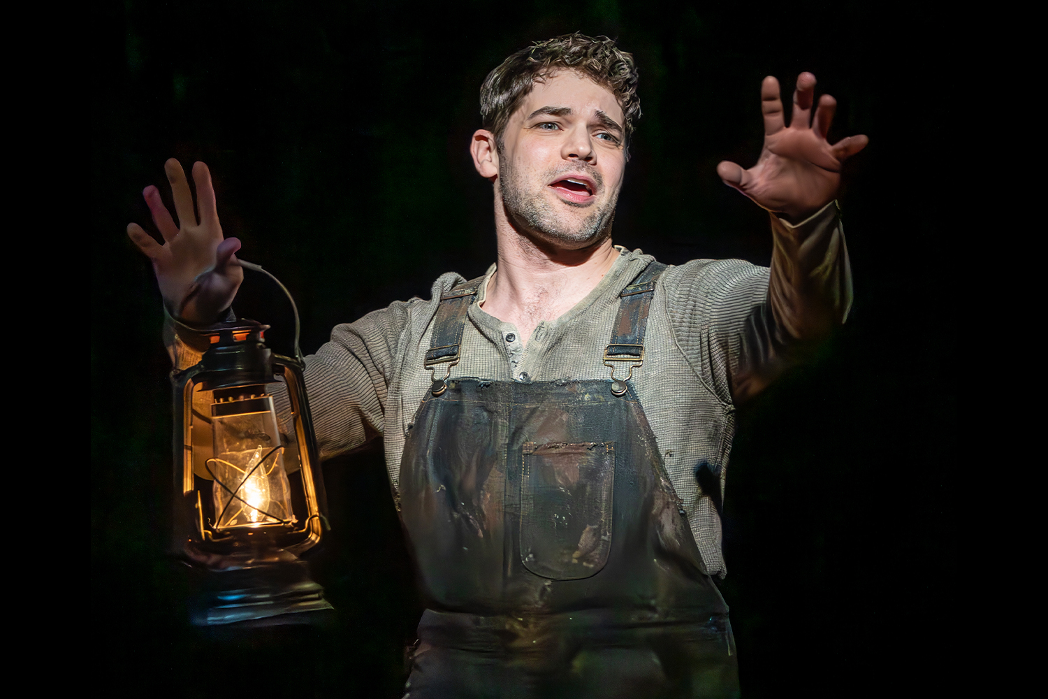 A man holding up a lantern