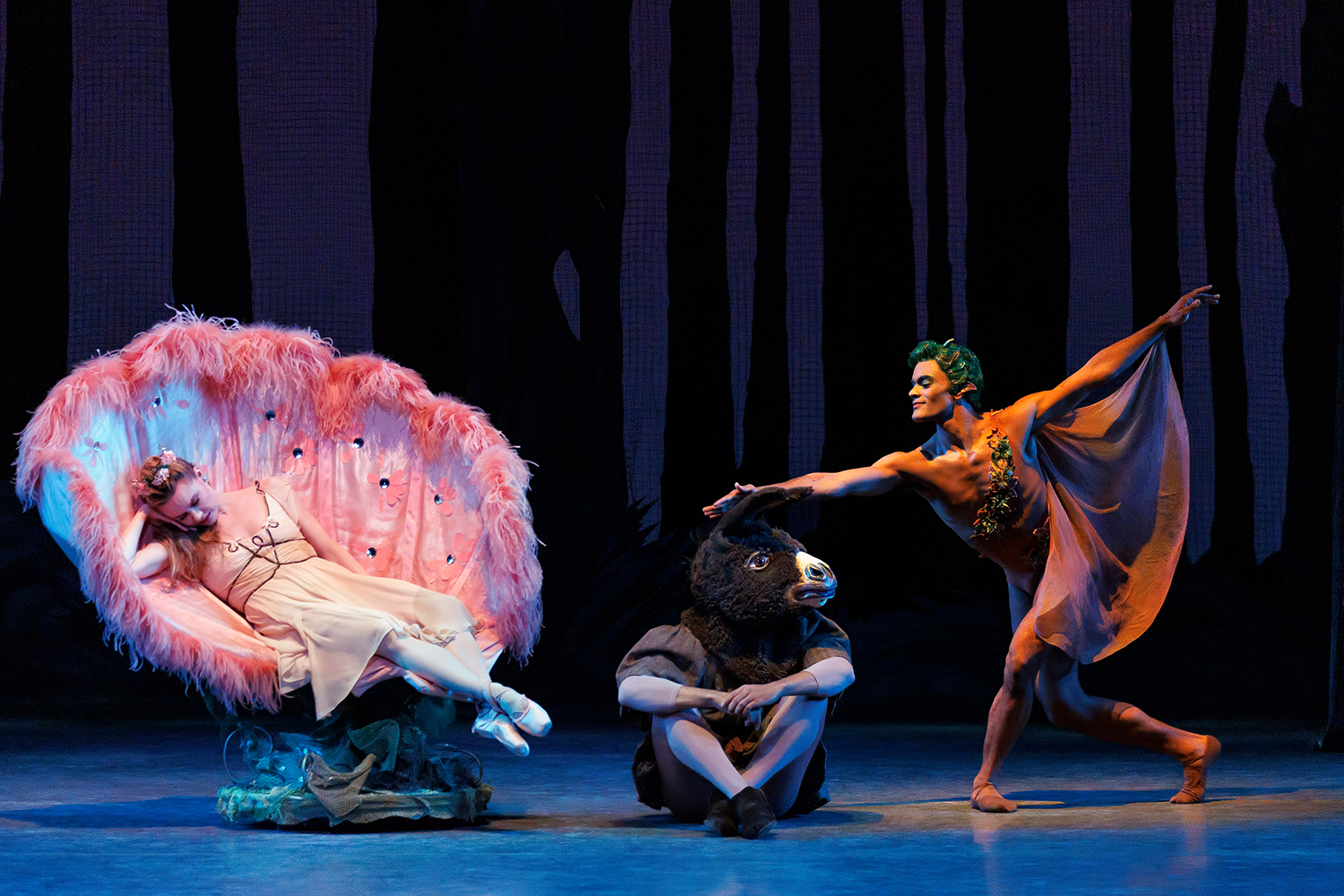 Ballet dancers in white outfits on stage