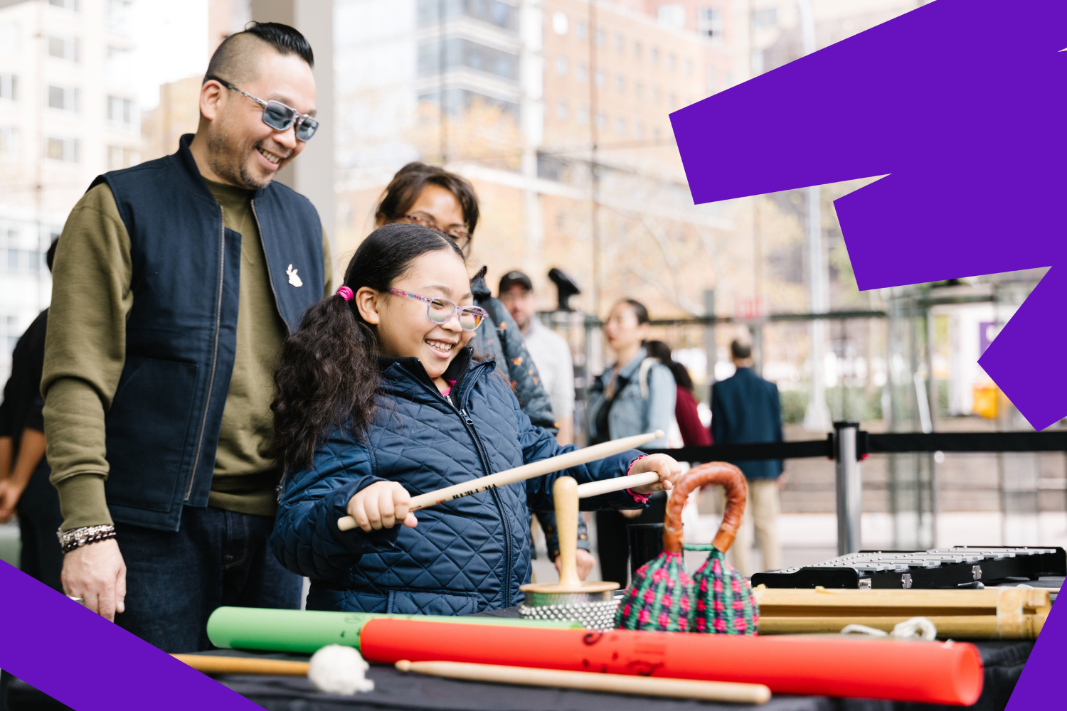 A man in a yellow t-shirt laying on his side in front of a projected version of Hamlet