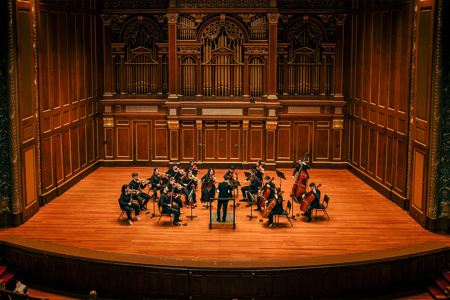A woman in overalls talking to a man in a black t-shirt
