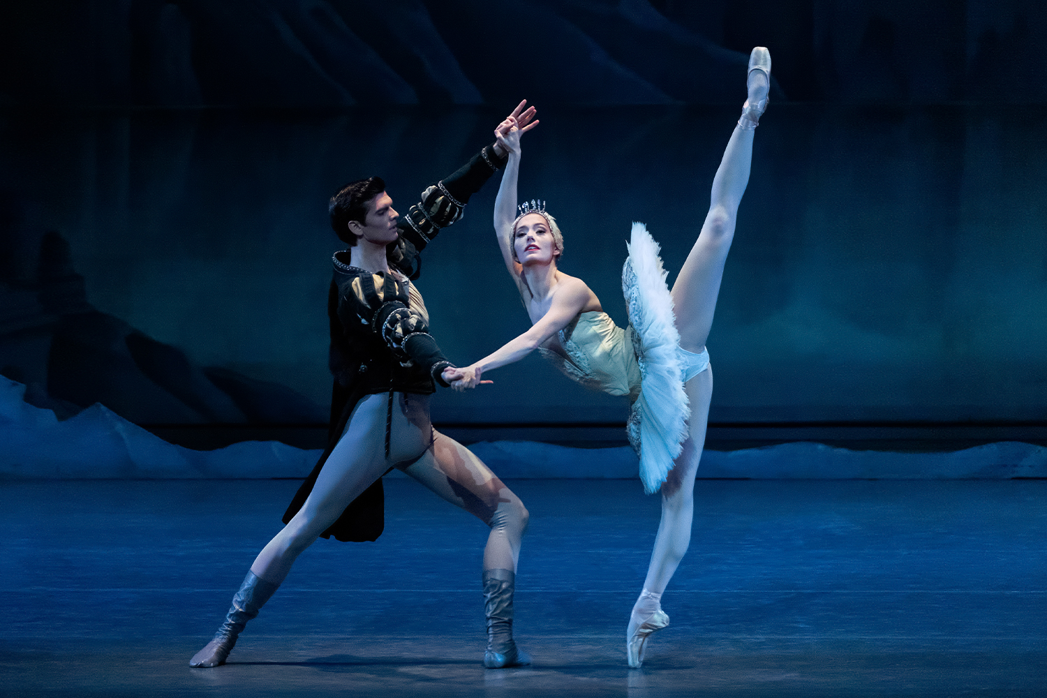 Ballet dancers in white outfits on stage