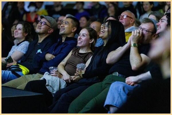 People sit in a row laughing