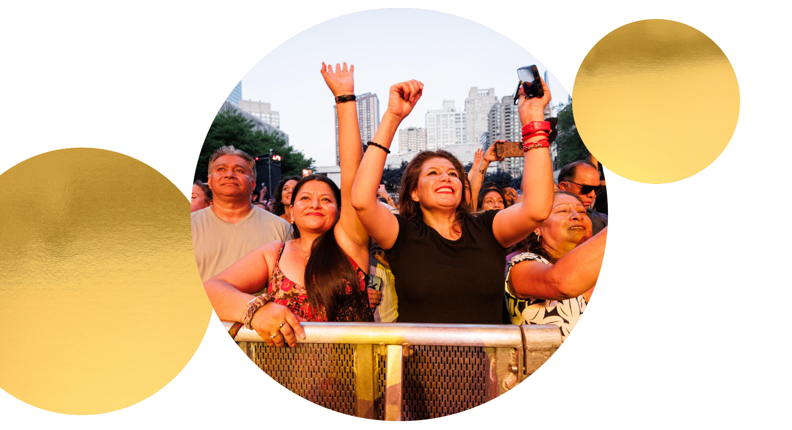 People in a crowd outdoors with arms raised