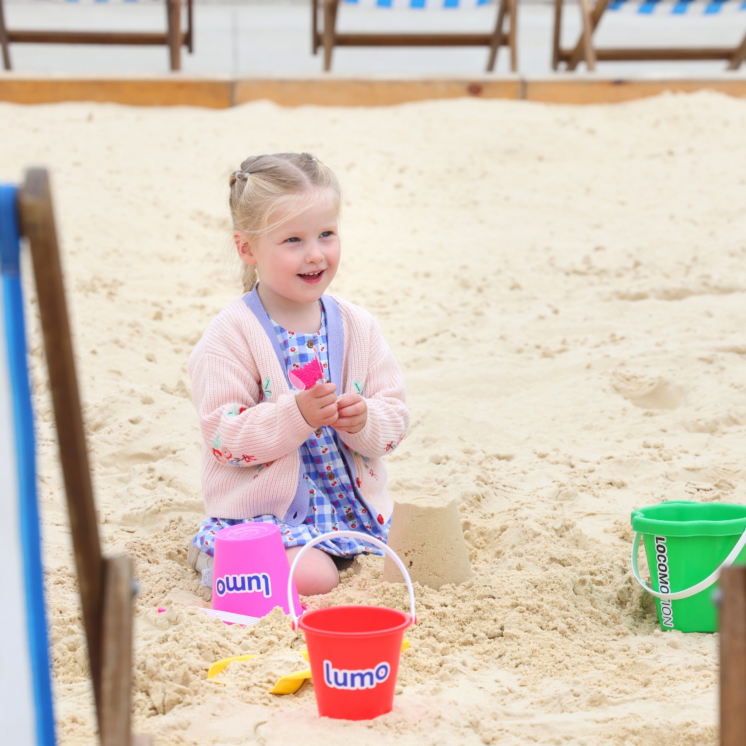A young girl playing on the pop-up beach at Locomotion