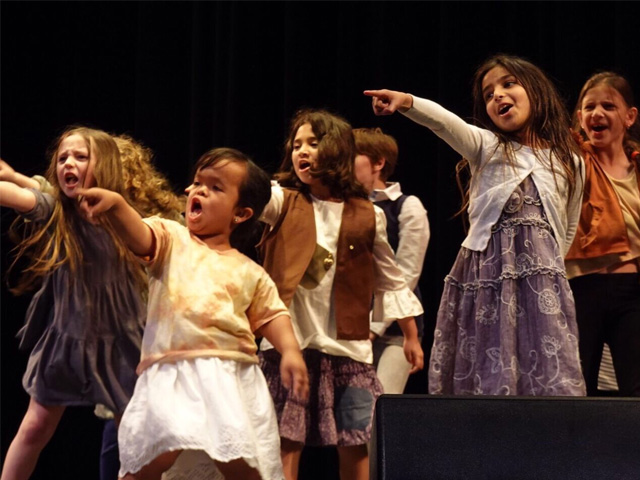 Kids on stage in a production of Annie
