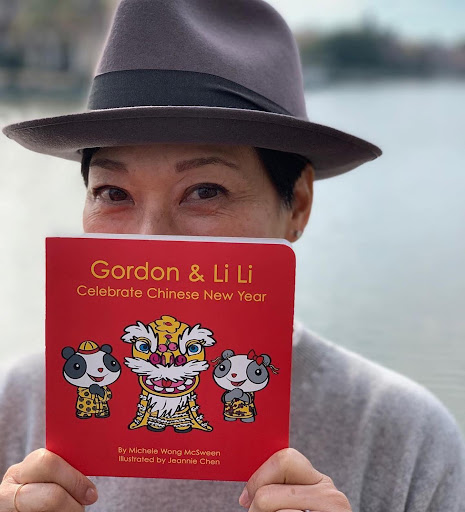Headshot of Michele Wong McSween holding the book Gordon & Li Li Celebrate Chinese New Year