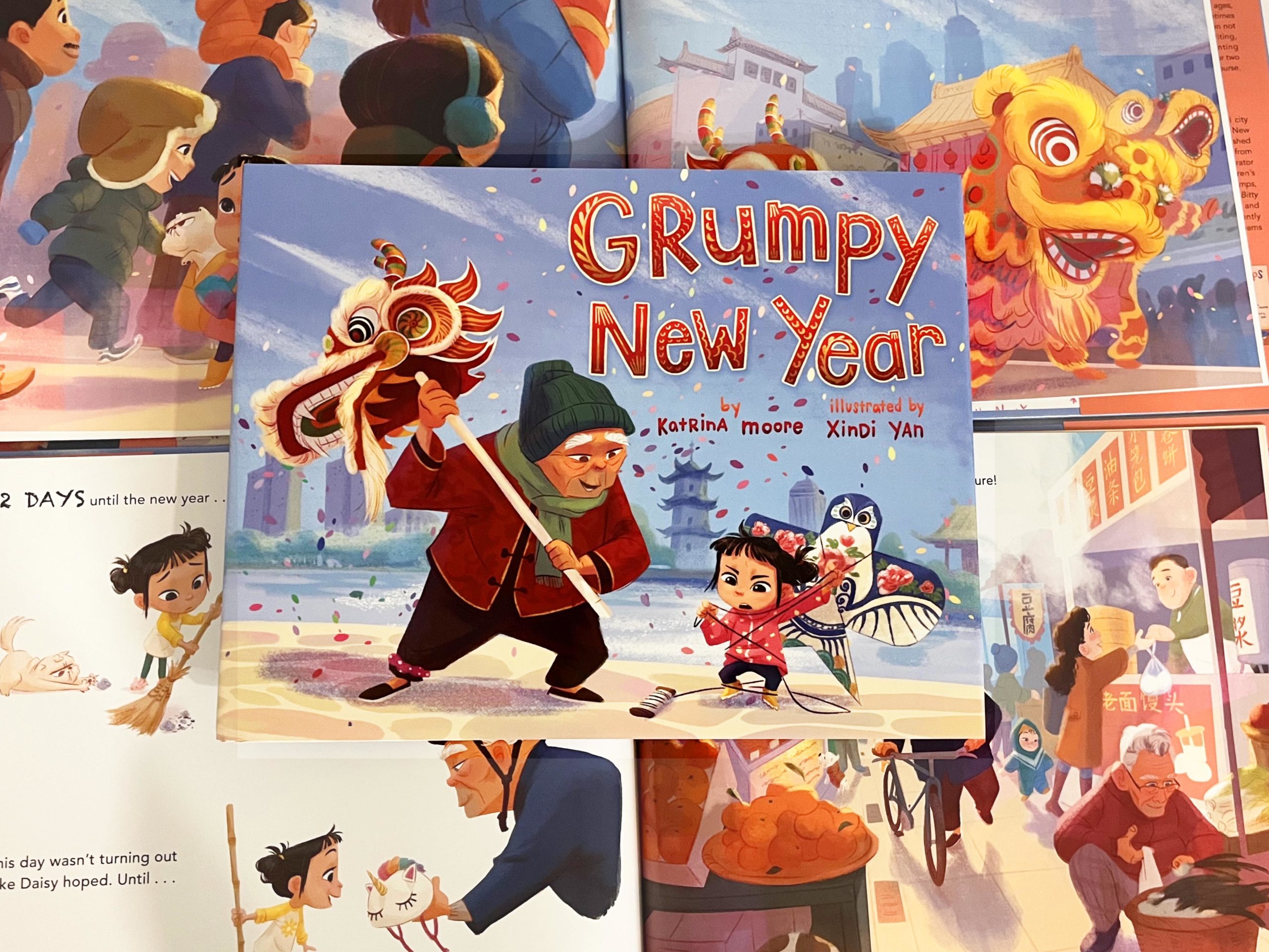 Cover of Grumpy New Year with page spreads behind