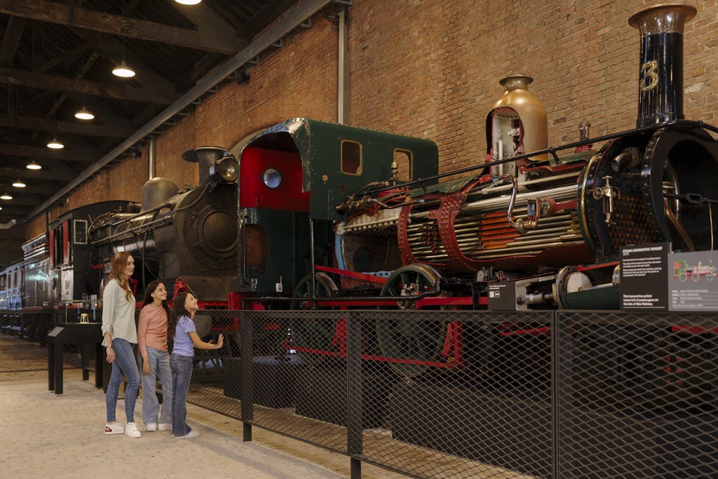 Family looking at a green locomotive