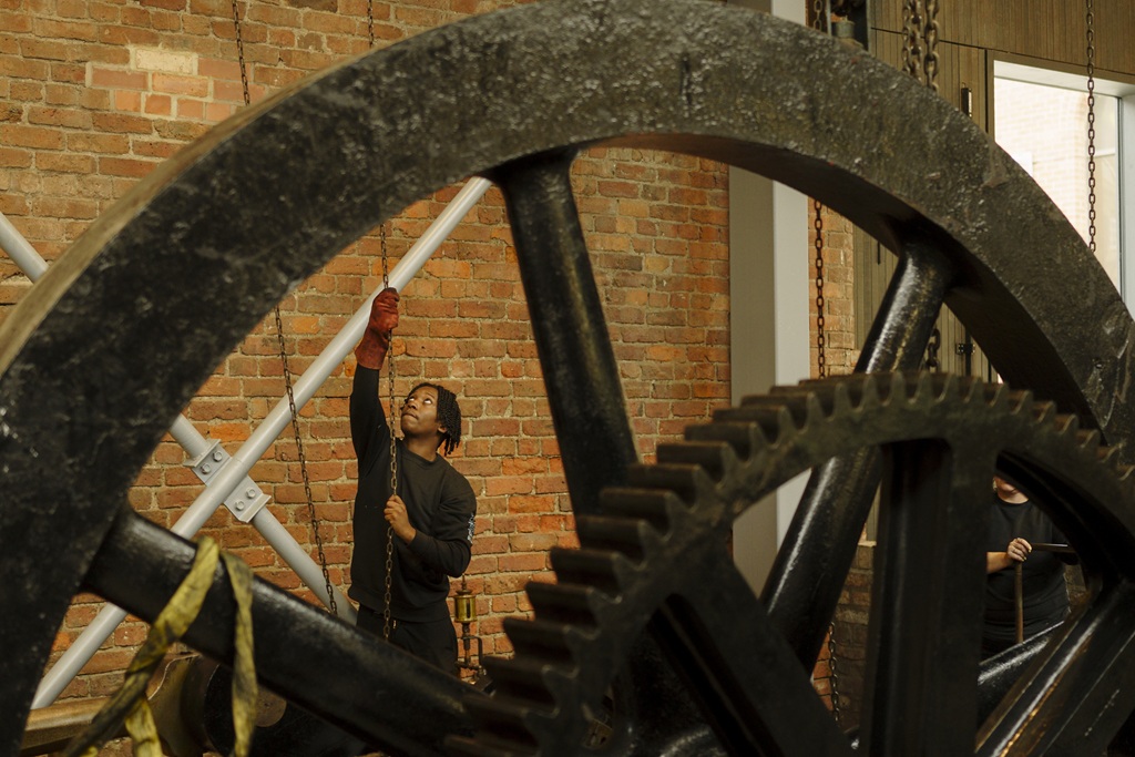 Museum technician working on a historic machine